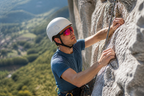 Climber on a rock face wearing camera glasses for hands-free point of view capture