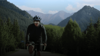 Cyclist riding through mountain roads for BleeqUp Rover 120-degree POV storytelling