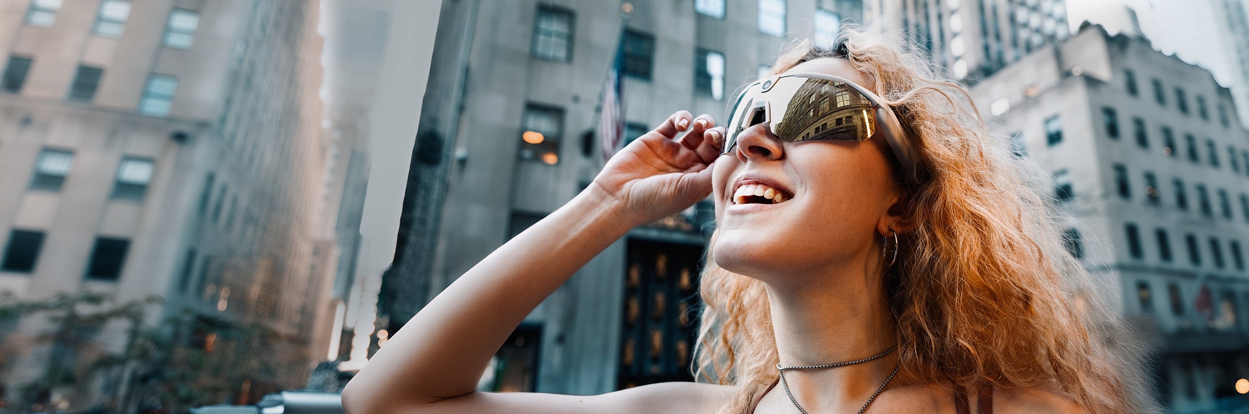 Woman wearing BleeqUp Ranger AI sports camera glasses in an urban vlog scene
